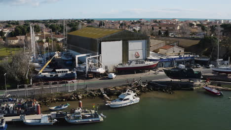 Giant-hangar-in-the-Grau-d'Agde-ship-repair-yard-aerial-drone-shot-sunny-day